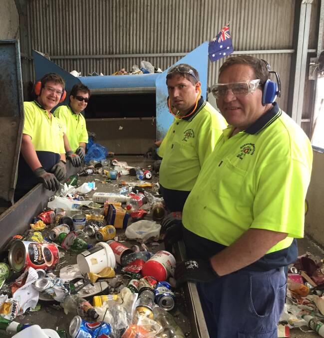 HARD AT WORK: Members of Gunnedah Workshop Enterprises sort through tonnes of recycling daily. Photo: Billy Jupp