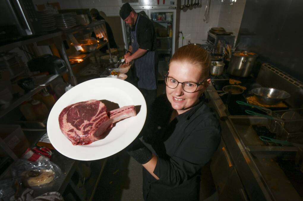 HUNGRY?: Lesley Amos shows off a 900 gram steak, which is the centrepiece of Bistro on Bligh's weekly Big T Challenge. Photo: Gareth Gardner 100720GGC01
