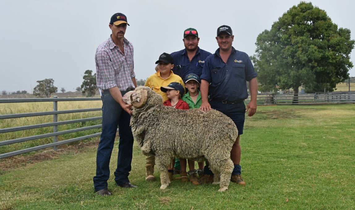 Vendor James Ballinger of Waverley Downs Merino Stud, buyers Kai, Levi, Maddison, Luke and Phil Taylor of Ford End Pastoral Company, Delungra with the top-selling ram. Photo: Billy Jupp 
