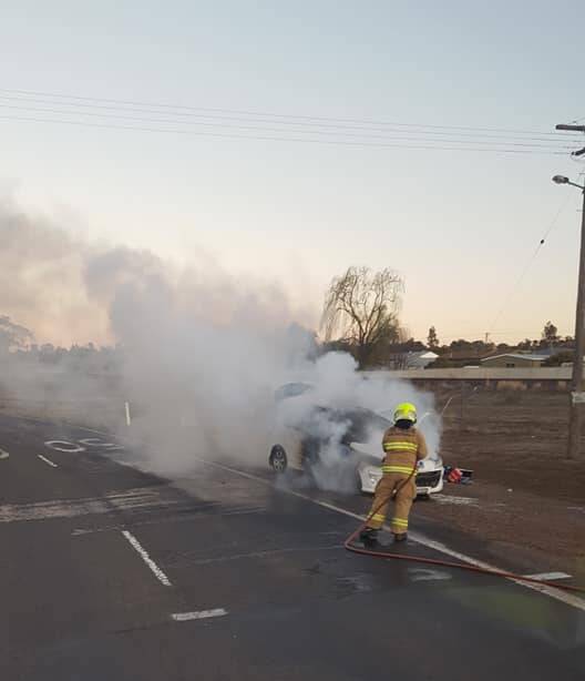 UP IN FLAMES: Gunnedah Fire and Rescue crews bring the car fire under control. Photo: Supplied 