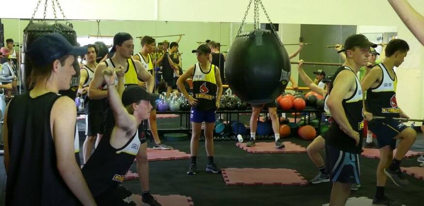 PUMPING IRON: The Northern Heat side hit the gym for their latest training session in Armidale. Photo: Supplied 