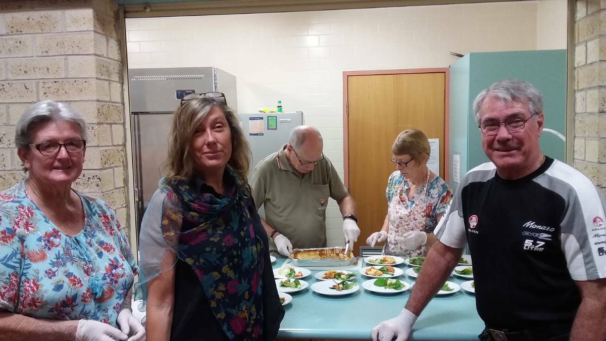 COMMUNITY SPIRIT: Sandra Tynan, Julie Collins, Bill and Jean Holder and Gavin Campbell are among the team of dedicated volunteers that has served up the weekly meals. Photo: File.