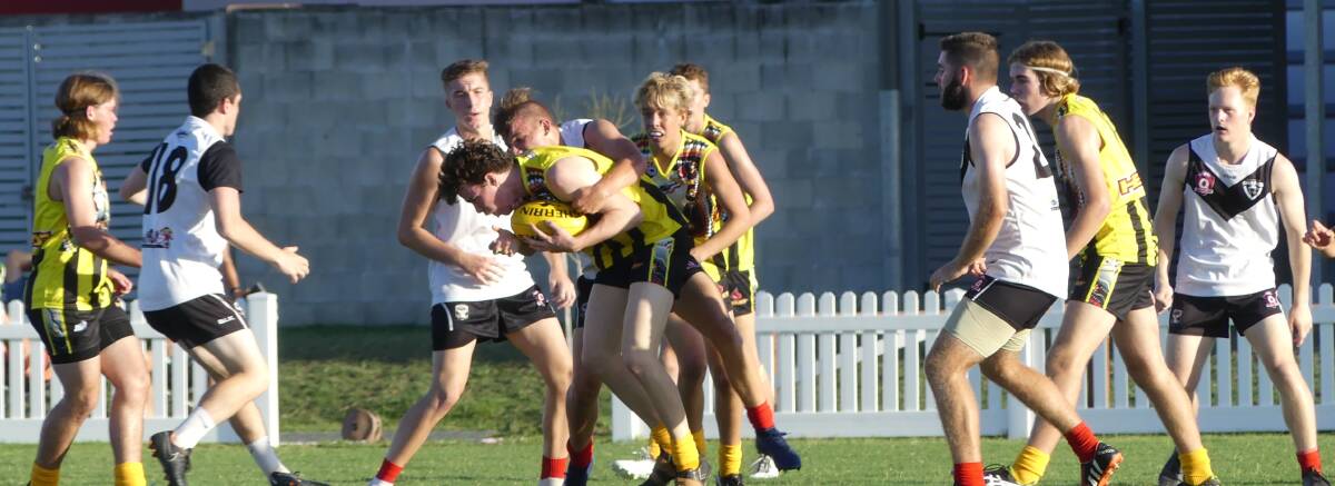 NABBED: Tamworth Swans' young gun Ed George is wrapped up in a strong tackle during the Northern Heat's clash on Saturday. Photo: Supplied 