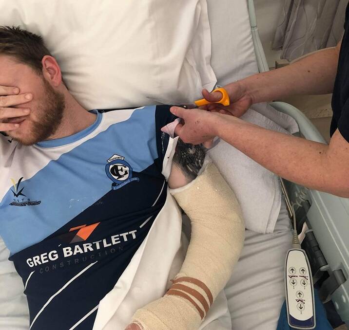 AGONY: Sam Williams can't bear to look as his beloved Tamworth FC jersey is cut off in hospital. Photo: Tamworth FC Facebook page 