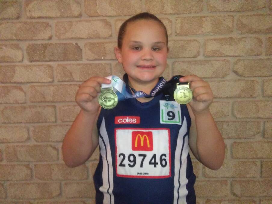 Tintinhull's Olivia Earl shows of her gold medals. 