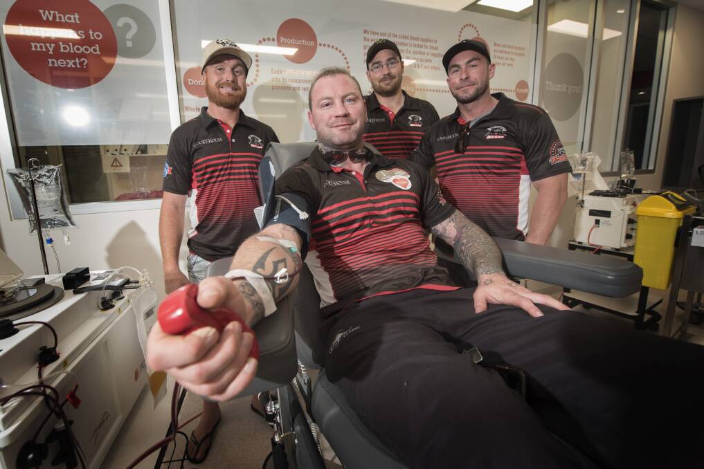 DIGGING DEEP: Luke Fisher, Daniel Semms and Nic Dobson rally around Josh Schmiedel as he donates blood. Photo: Peter Hardin 080719PHG005 