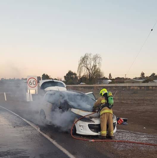 UP IN FLAMES: Gunnedah Fire and Rescue crews bring the car fire under control. Photo: Supplied 