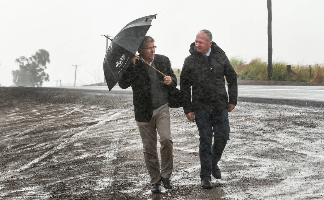 SAFETY FIRST: Tamworth mayor Col Murray and New England MP Barnaby Joyce brave the weather to inspect the latest upgrades to Werris Creek Road. Photo: Gareth Gardner 270720GGB01