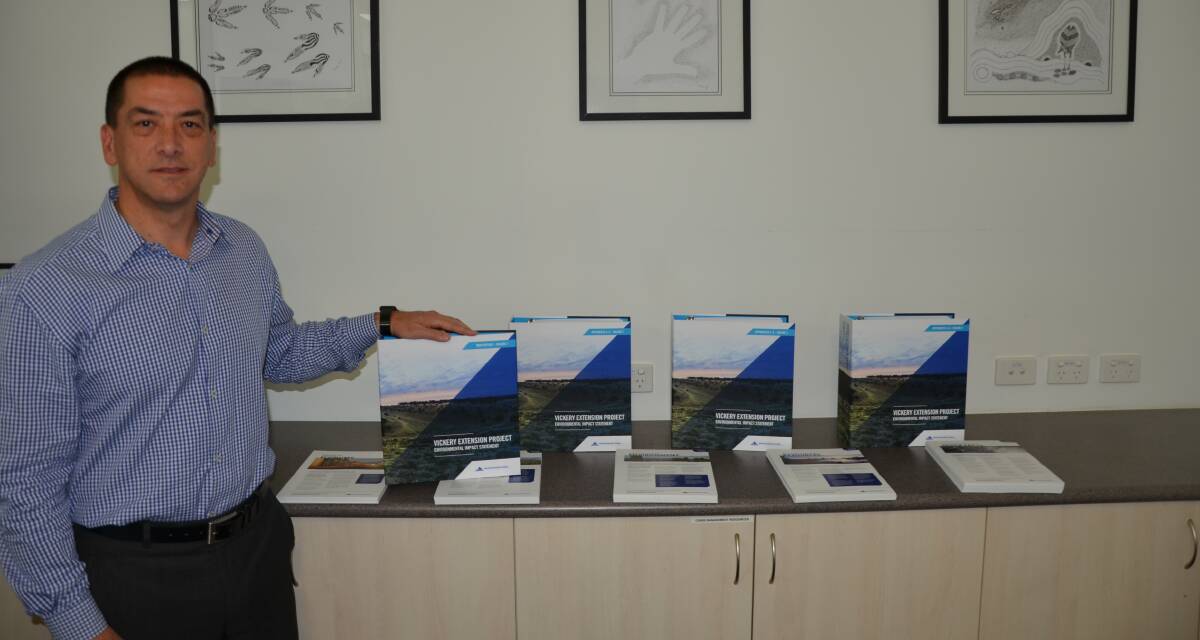 ON DISPLAY: Whitehaven Coal CEO shows off the five volumes of the Vickery environmental impact statement in Gunnedah on Thursday. Photo: Billy Jupp 