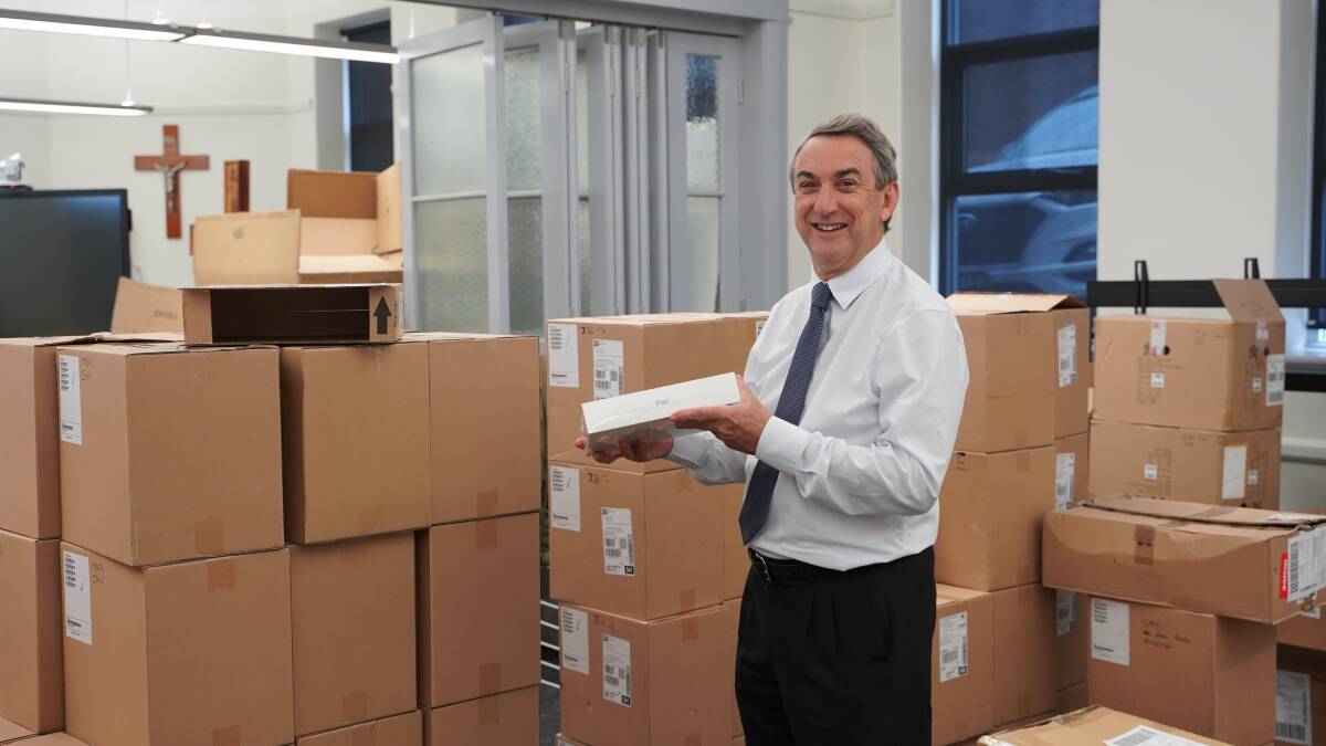 HAPPY NEW YEAR: Director of Schools, Chris Smyth last week with new ICT resources (including ipads, laptops, screens) ready to go out to schools. Picture: supplied.