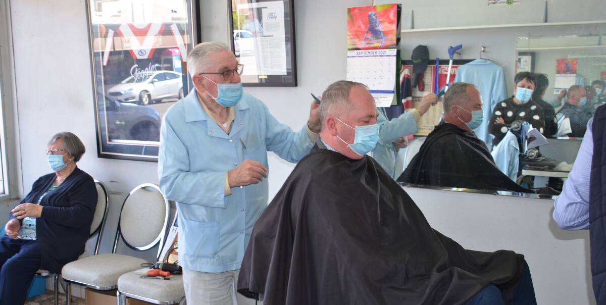 BARBERING BARNABY: Retired barber Roy Cowley cuts acting Prime Minister Barnaby Joyce's hair on his last day in the shop after 70 years. Photo: Vanessa Arundale