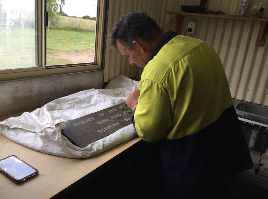 Andrew hand carves the new memorial plaques on the stone he sourced which was quarried more than a century ago