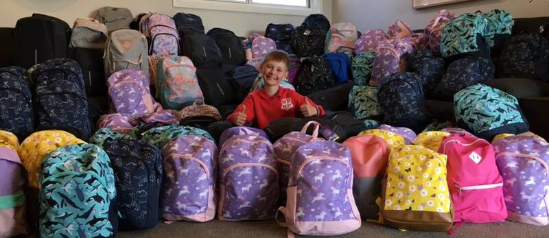 Simon Wellings with the backpacks he collected to ease the transition of foster children into their new homes.