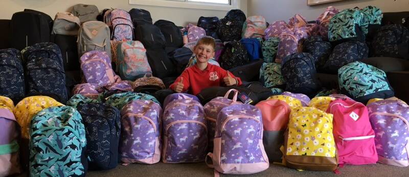 TOP EFFORT: Simon Wellings with the backpacks he collected to ease the transition of foster children into their new homes. Photo: Supplied