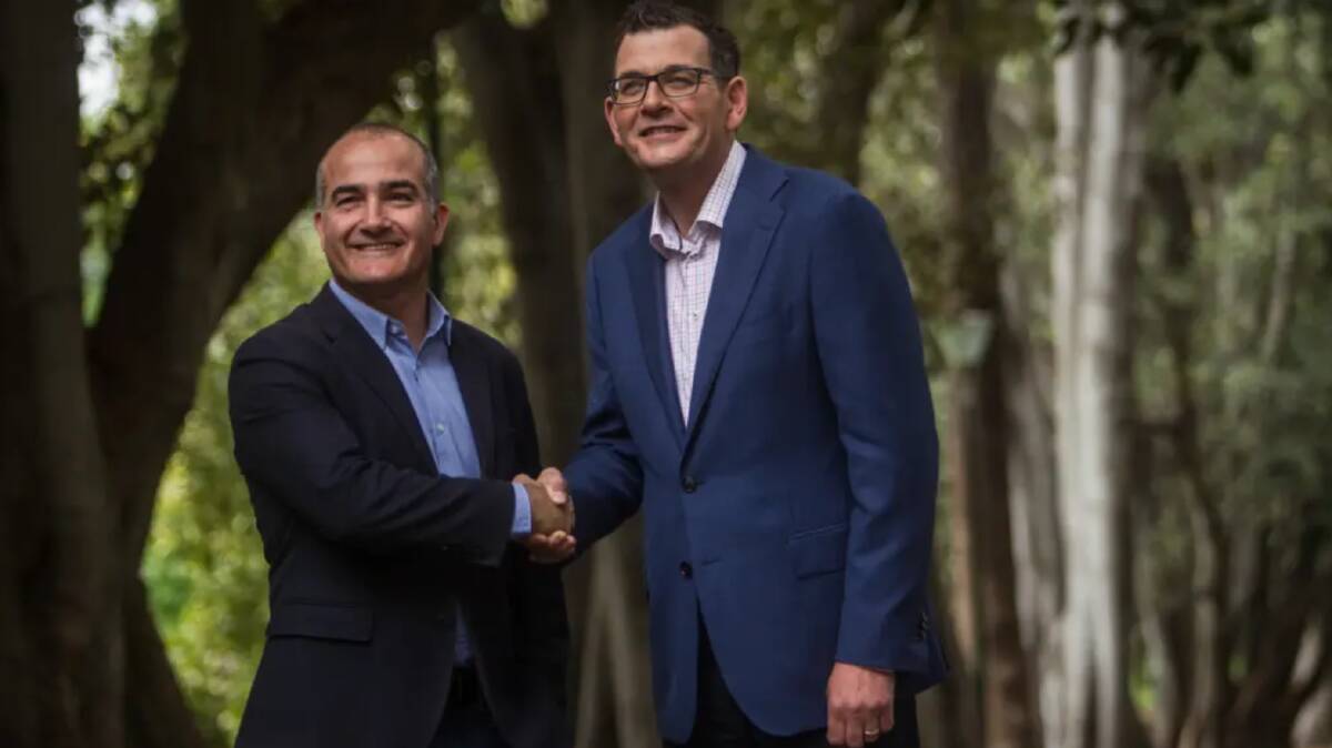 A jubilant re-elected Premier Daniel Andrews (right) on a Sunday stroll with his deputy and friend James Merlino. Photo: Scott McNaughton