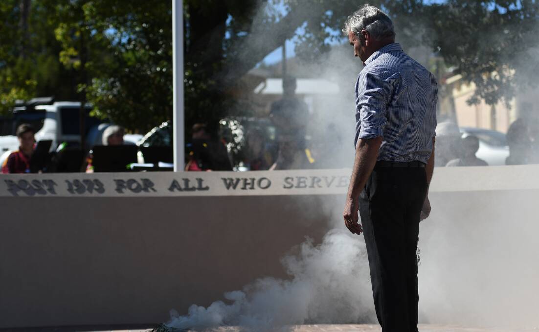 Gomeroi elder, Uncle Len Waters, conducts a smoking ceremony at the Post 1973 Memorial event. 050418GGC010