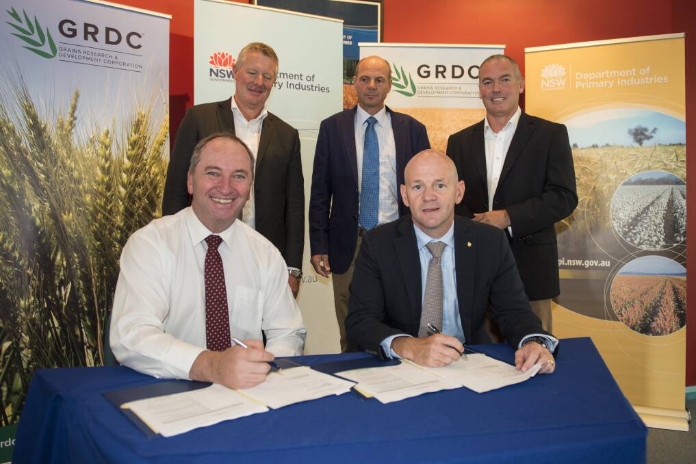 FUNDING FIRMED: Acting Prime Minister Barnaby Joyce and NSW Primary Industries Minister Niall Blair, front, sign the bilateral agreement watched by GRDC chairman John Woods, GRDC managing director Steve Jeffries, DPI director-general Scott Hansen. Photo: Peter Hardin 170217PHA026