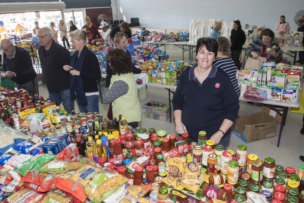 GENEROUS: Salvation Army captain Rhonda Clutterbuck with the piles of food donated so far. Photo: Peter Hardin 030818PHB008