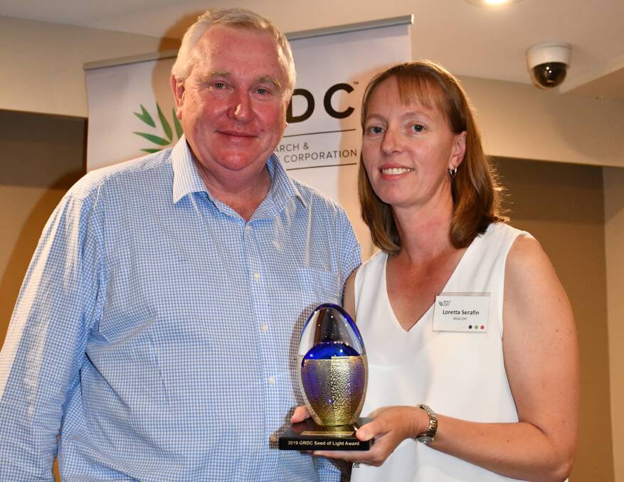 DESERVING: GRDC northern region panel chairman John Minogue presented Loretta Serafin with the GRDC Seed of Light at a dinner in Goondiwindi. Photo: GRDC
