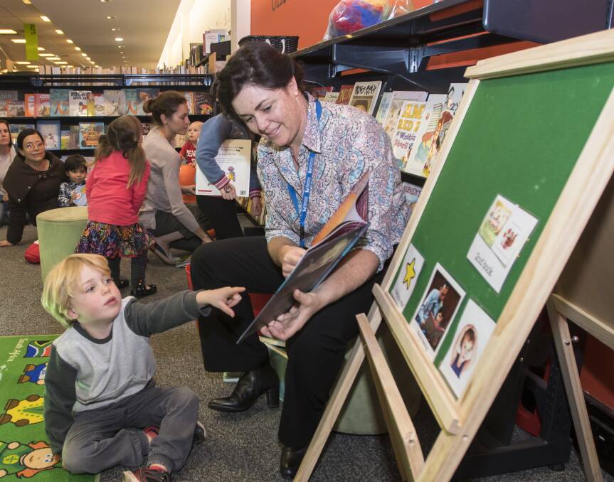 READ IT AGAIN: Kelly Makepeace and little James O'Leary read Hickory Dickory Dash together at Tamworth City Library. Photo: Peter Hardin 230518PHC013
