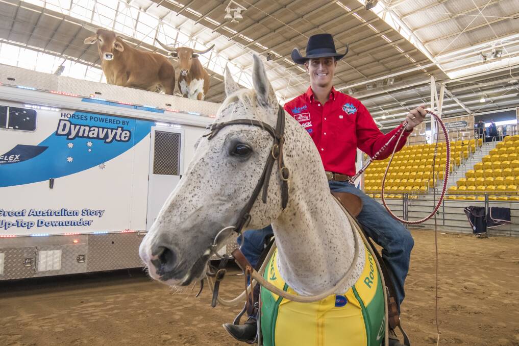 EXCITED: Dave Manchon, the director of the Rooftop Express Wild West Arena Show, and Australian stock horse Mr Bonbastic, one of the stars of the show - note the steers on the roof of the trailer behind. Photo: Peter Hardin