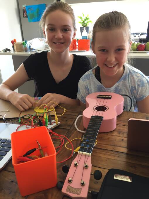 MAKEY MAKERS: Calli Nagle, 12, works on her DJ turntable and Lucy Lyden, 10, on her hacked ukulele at Tamworth Tech Camp today. Photos: Carolyn Millet