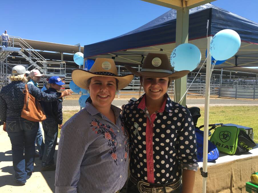 SUPPORT: Grace Purtle and Issy Burke held an awareness and fundraising campaign at Tamworth Regional Livestock Exchange on Friday.