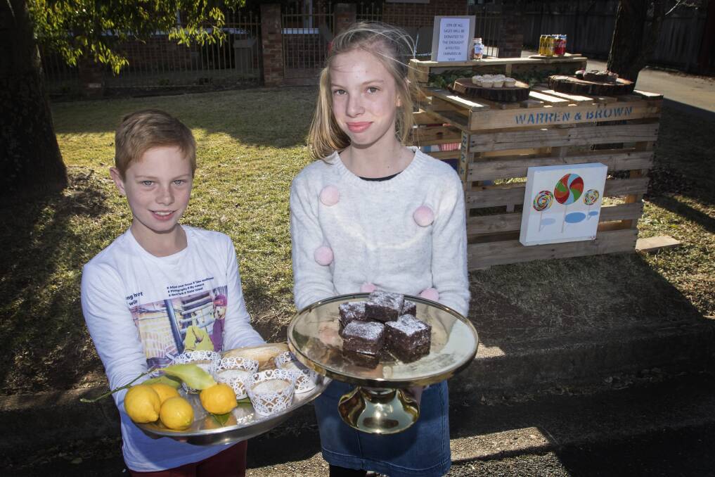 TASTE FOR CHARITY: Cooper and Opal Wright built their own cupcake stall to raise money for drought help. Photo: Peter Hardin 200718PHC009
