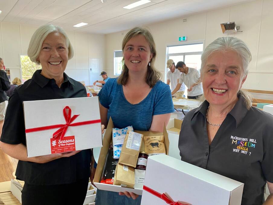 BUSY BEES: Wendy van Ekert, Tara Toomey and Anne Mayo were among a couple dozen people who packaged up the hampers to be delivered to Sydney. 