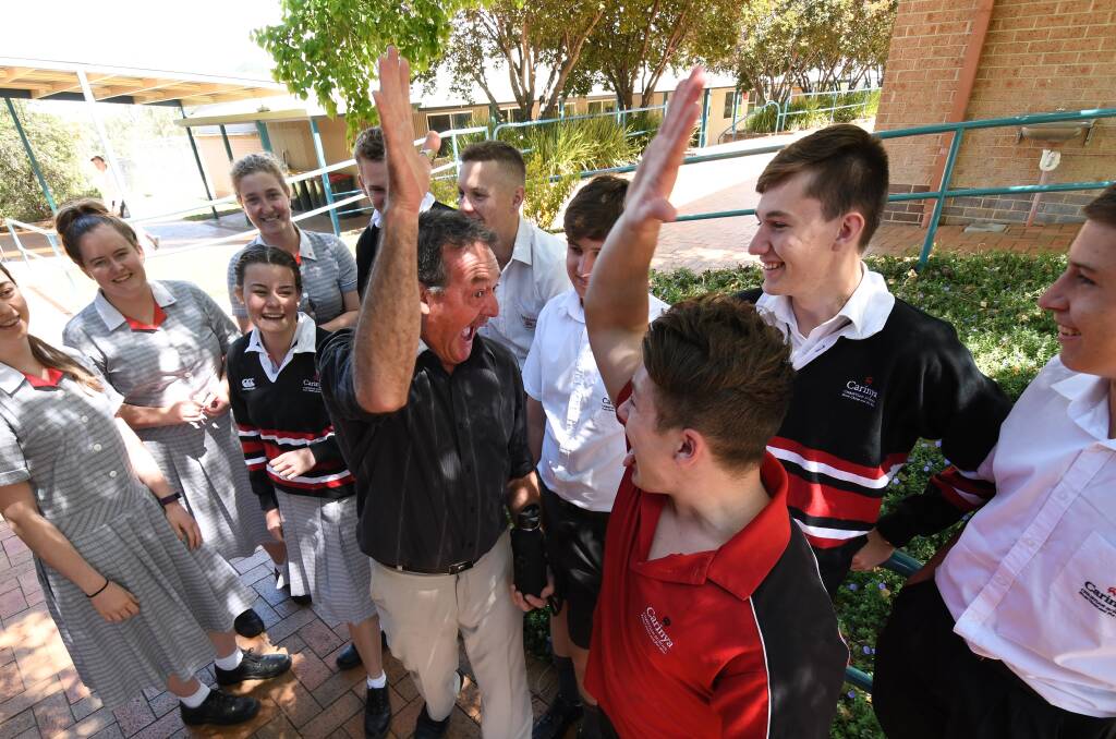 HIGH FIVE: Teacher Jim Lamrock, student Lochie Urquhart and some of his classmates celebrate the end of the HSC exams yesterday. Photo: Gareth Gardner 071117GGB002