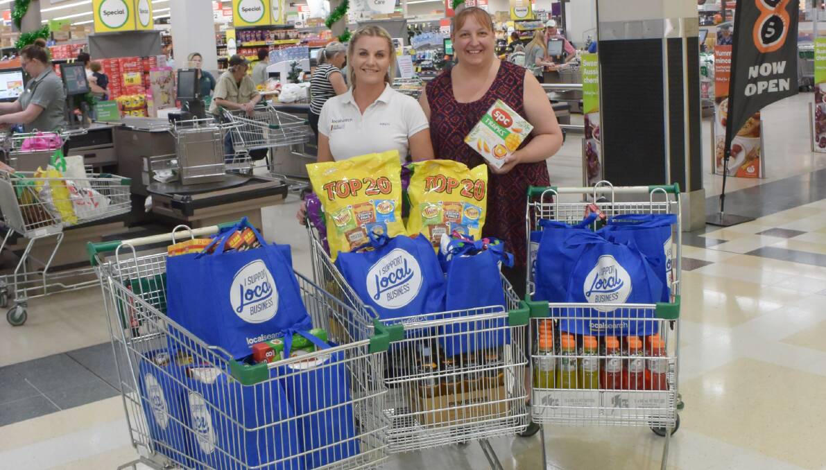 BUYING UP: Local Search's Kirsty Sutcliffe and Kings Brake Services' Jenny King - a client who put her hand up to help with the task - with the goods they picked out on Thursday afternoon. 141119CMB01