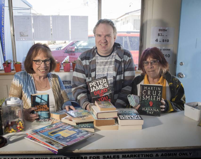 AVID READERS: Rosemary White, Byron Kolln and Maralyn Kolln with some of their recent purchases. Photo: Peter Hardin 110919PHC007