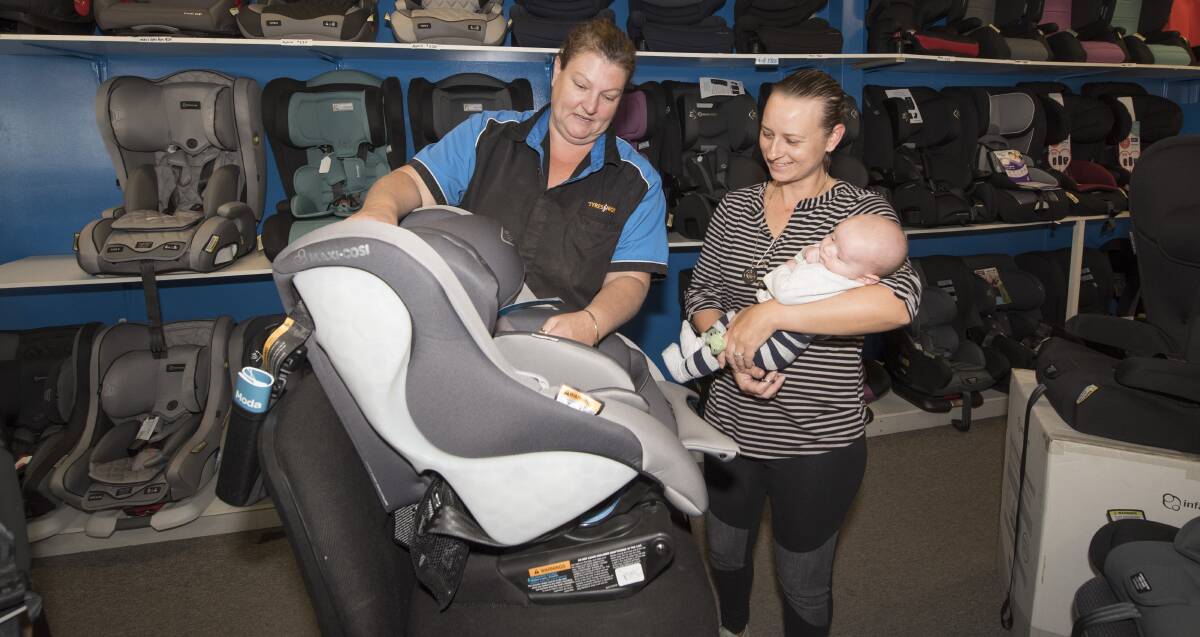 SEAT SAFETY: Authorised child restraint fitter Neroli Smith with new second-time mum Deanna Sipple and Beau Turner. Photo: Peter Hardin 140519PHE026
