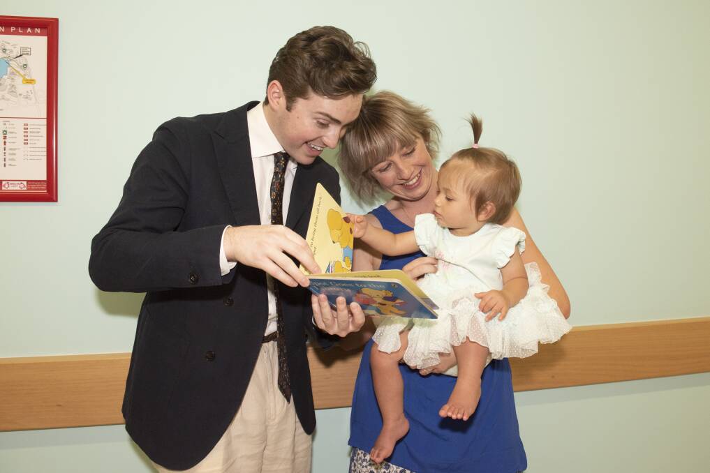 WOWED BY WORDS: Imagination Library ambassadors Harrison Craig, Ashleigh Dallas and her baby Harriet. Photo: Peter Hardin 201119PHE065