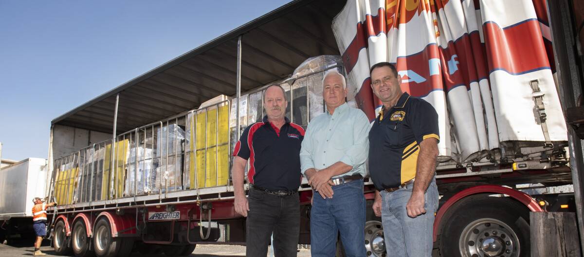 PALLETS FOR PALS: Dave McCoy, Greg Watson and Greg Townsend were on hand to receive the donations. Photo: Peter Hardin 071119PHA016