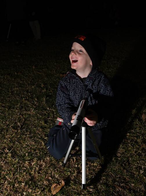 LITTLE STAR: Benjamin Parker, 3, took part in the event using one of the small telescopes registered participants were able to buy for $7.15. 240518GGA005