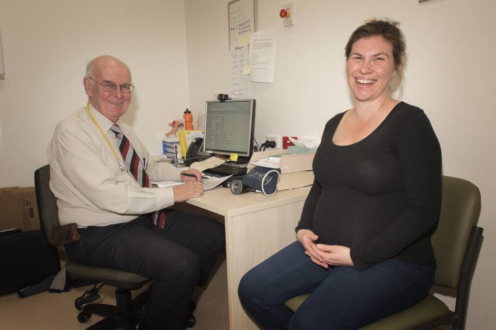 Happy times: Keith Hollebone with patient Helen Cameron at the regular antenatal clinic during his last week of working as an obstetrician-gynaecologist. 120619PHD026