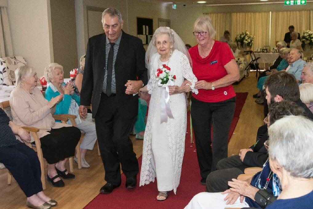 Resident Betty Bass played a bride and volunteer Lawrence Asseff the father of the bridge, with the help of RFBI Tamworth Masonic Village general manager Liz Diebold. Photo: Peter Hardin 140218PHA155