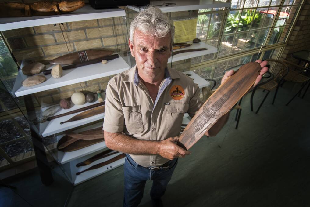 SAFE PLACE: Len Waters with one of the artefacts housed and available to look at and touch in the Tamworth Regional Botanic Garden's new keeping place and cafe. 040219PHA031