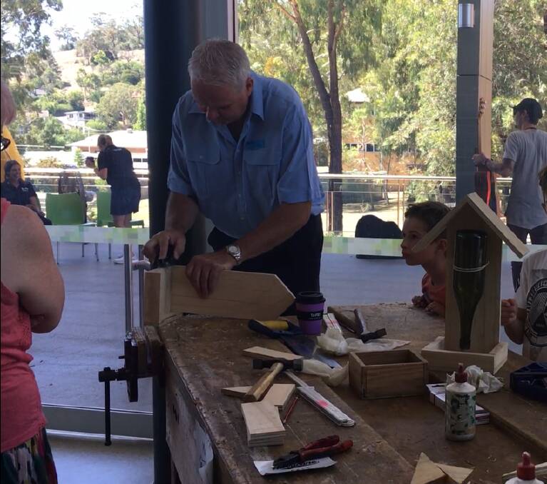SKILLS ON SHOW: Building and construction head teacher, Grant Bowden, demonstrates building a bird feeder in 20 minutes, as spectators watch, at the open day at TAFE NSW Tamworth campus.