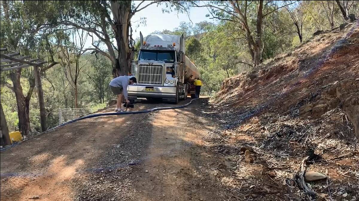 IN IT COMES: The water tanker starts pumping at one local landholder's property. 