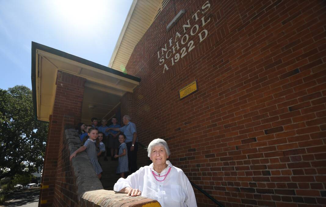 Joan Newley, here in front of the building named after her, says she loves returning to the school to share her experiences. 200318GGB015 