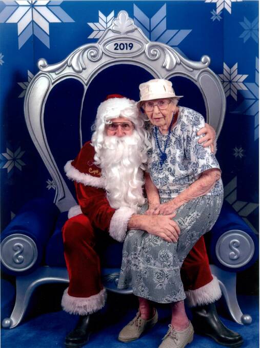 Never too old: Phyl Bylund sits on Santa's knee just before Christmas.