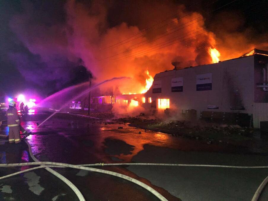 TEAMWORK: Firefighters battle the blaze in the warehouse, which started late on Monday night. Photo: Fire & Rescue NSW