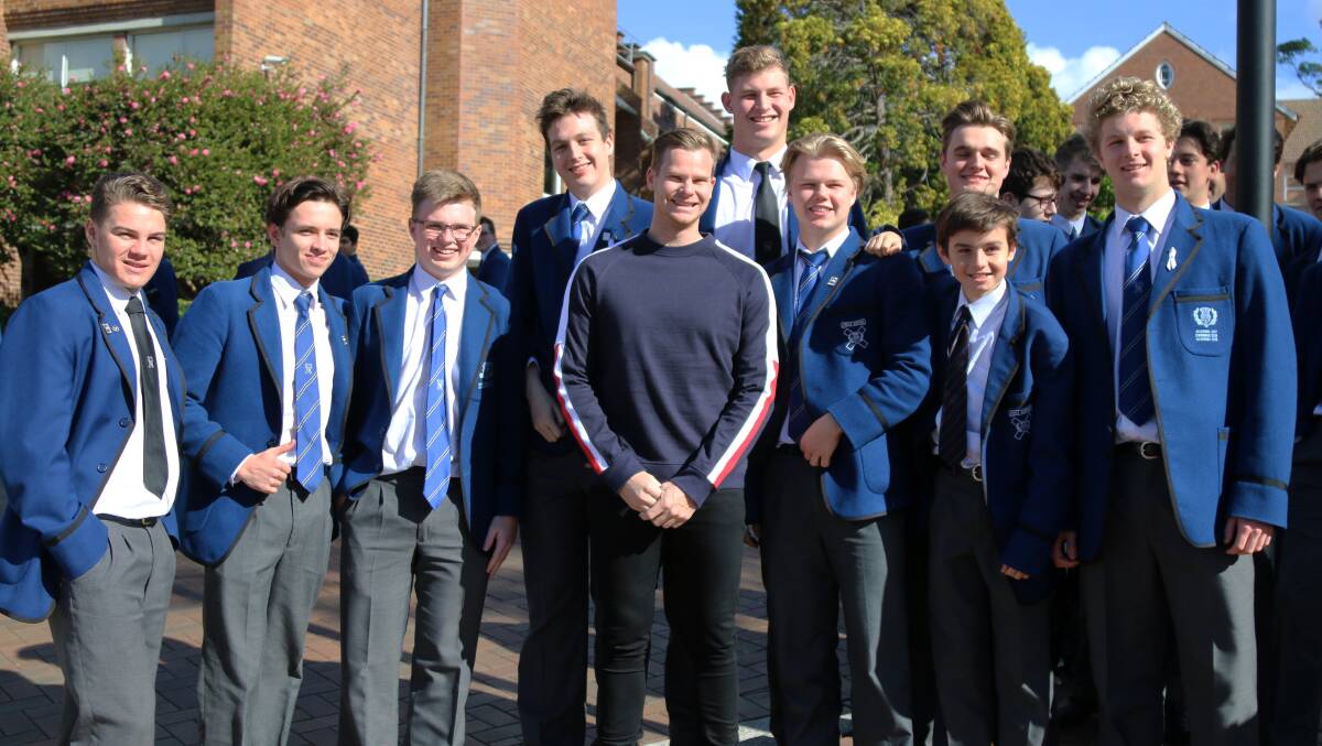 Former Australian cricket captain Steve Smith (centre) meets some of the Knox Grammar boarding boys during his special visit to talk about mental health.