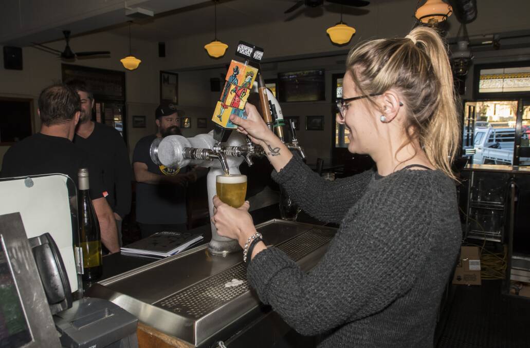 Beers for bales: Lucy Smith pours a schooner of relief at the Tamworth Hotel for Karma Keg Friday. Photo: Peter Hardin