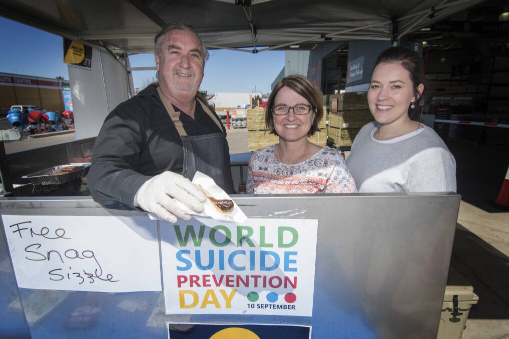 Serving suggestions: Francis Hayes, Kerryn Smith and Alex Stephenson serving up sausage sangas and salvation at Bunnings on Tuesday. Photo: Peter Hardin 100919PHC05
