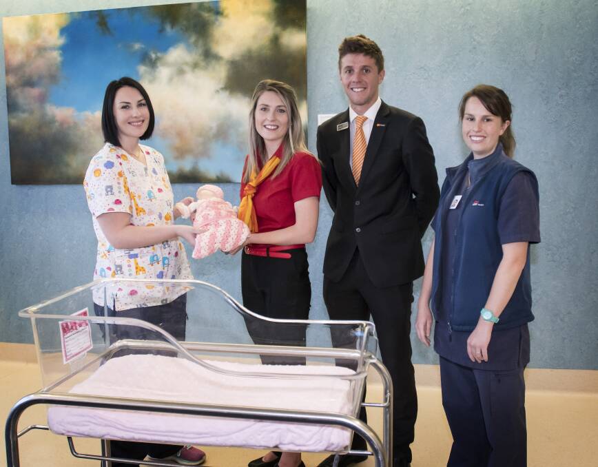 Baby boom: Katelyn and Sam Spokes, pictured centre, deliver the Baby Umbi Manikin to Stephanie Iliffe, left, and Rebecca Sharpe, right. Photo: Peter Hardin