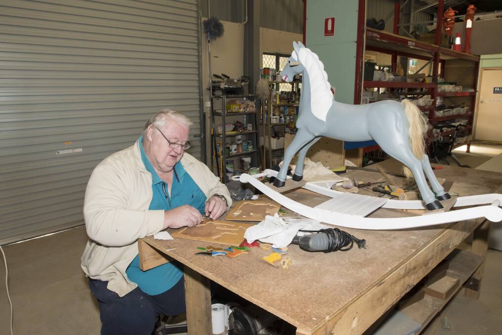 Inclusive industry: Athol Lathan can'rt stand for long, but can sit down to completely refurbish this rocking horse with everything he needs on hand. Photo: Peter Hardin