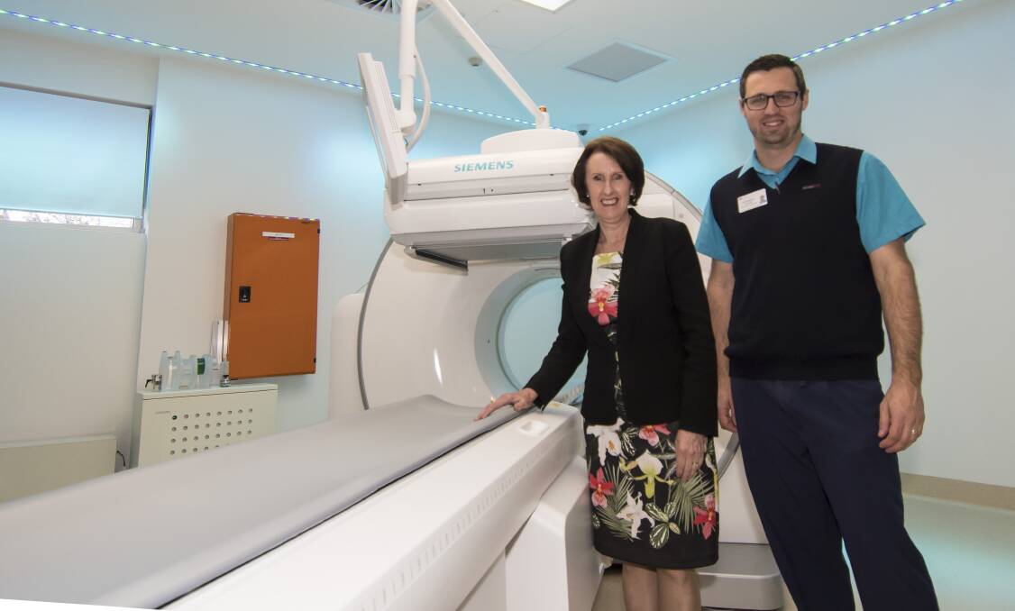 State of the art: Parliamentary secretary Leslie Williams with assistant nuclear medecine chief Chris Skilton and the new 'gamma camera' CT machine at the hospital. Photo: Peter Hardin